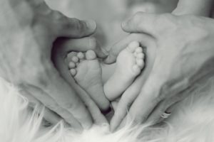 baby feet in adult hands